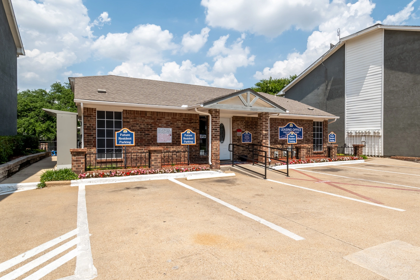 Leasing office and parking area at Crossings at Irving in Irving, Texas