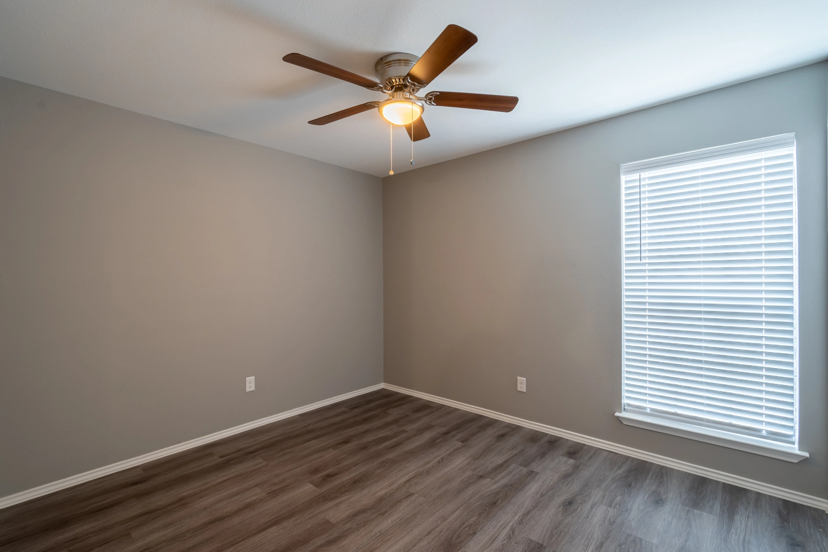 Bedroom with wood-style flooring at Crossings at Irving in Irving, Texas
