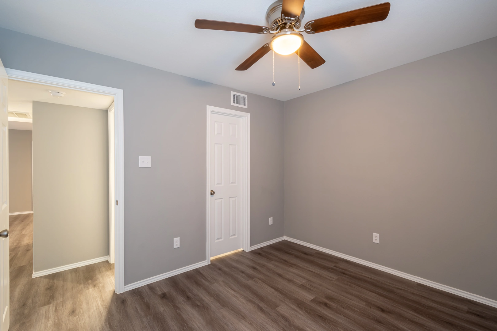 Bedroom with walk-in closet access at Crossings at Irving in Irving, Texas