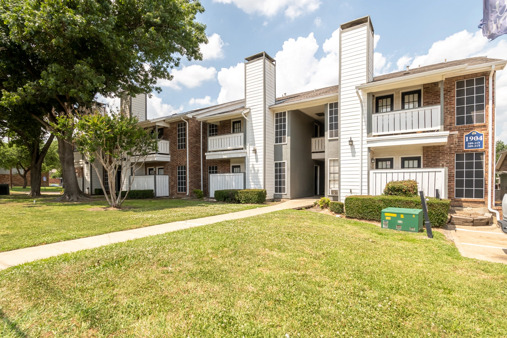 Apartment buildings and walkway at Crossings at Irving in Irving, Texas