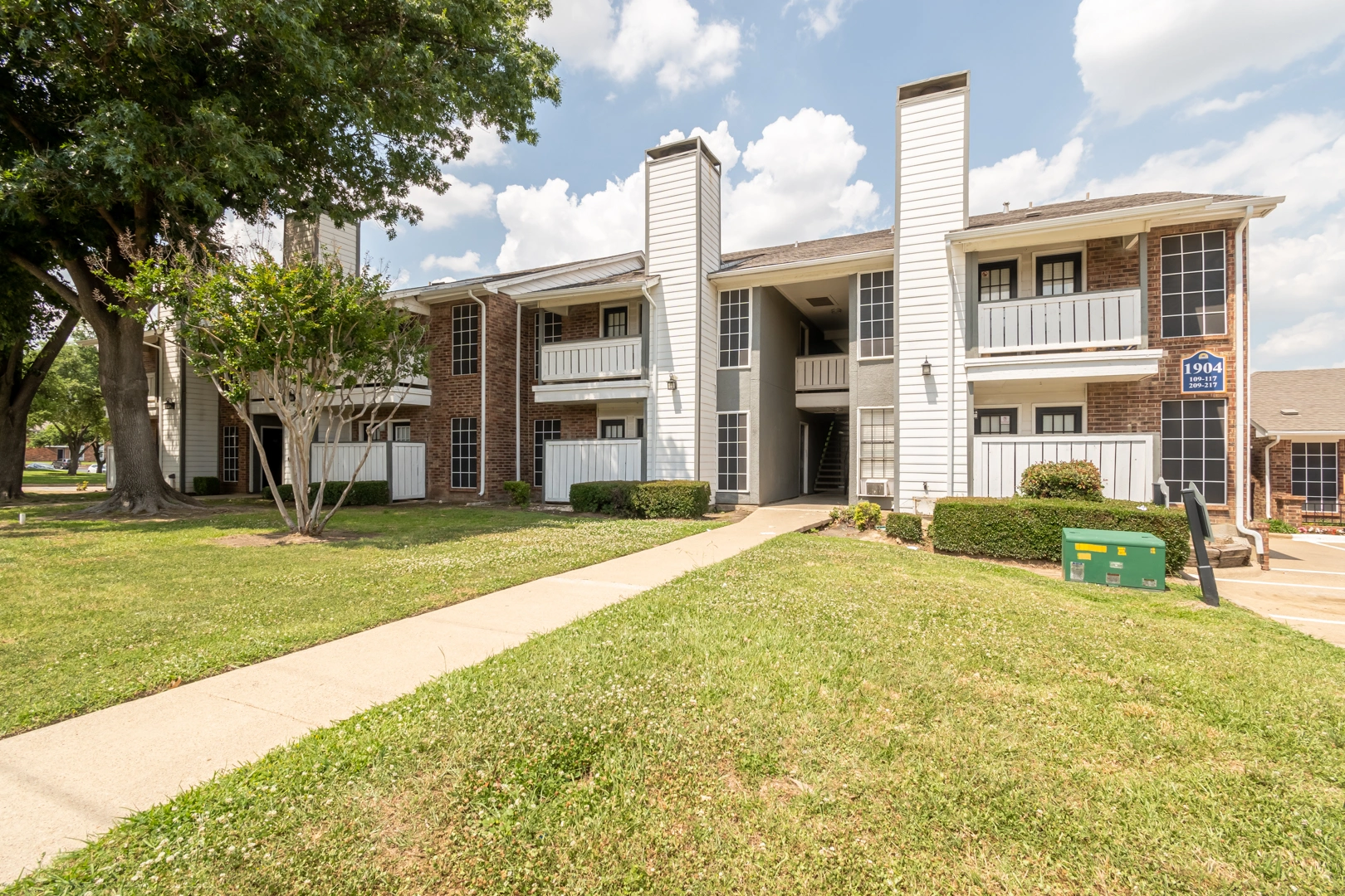 Landscaped residential buildings at Crossings at Irving in Irving, Texas