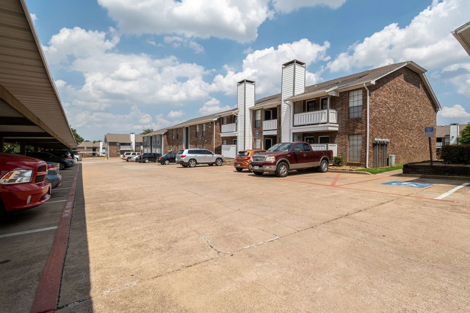 Parking lot and covered carports at Crossings at Irving in Irving, Texas